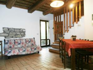 a living room with a table and a couch at Antico Fienile in Serravalle