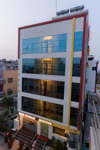 an office building with the lights on at Hotel Mookambika Comforts in Tirupati