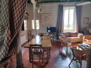 a living room with a table and a couch at Au Château Juillac in Juillac