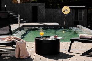a swimming pool with a glass of wine and a table at SPA Resort St Ivan Rilski - Halfboard & All Inclusive in Bansko +172 photos