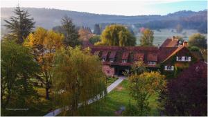 a large house with trees in front of it at Bleu Minuit L'Arche in Obersteinbach