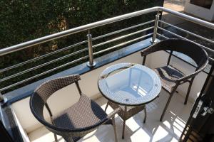 two chairs and a table on a balcony at Los Lagos Resort Hotel in Capiatá