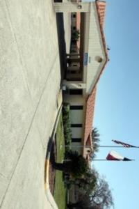 a person is standing next to a tall building at Edinburg Executive Inn in Edinburg