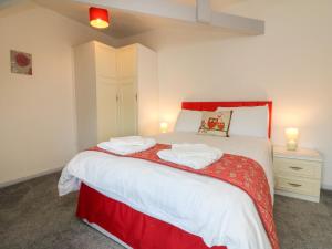 a bedroom with a bed with two towels on it at The Loft in Holsworthy