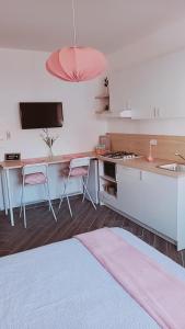 a kitchen with a sink and a table with chairs at DIMENTICA IL CERVELLO in Palermo