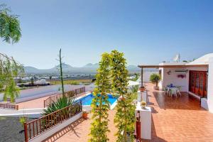 a house with a swimming pool and a patio at Modern Villa in Nazaret with Private Pool in Nazaret