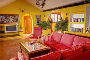 a living room with a red couch and a tv at Modern Villa in Nazaret with Private Pool in Nazaret