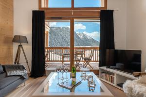 a living room with a view of a mountain at Perle de Savoie - Apt C601 - BO Immobilier- Reduced prices on ski passes Châtel & Portes du Soleil in Châtel +6 photos