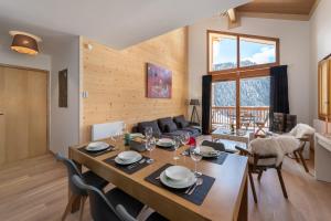 a dining room and living room with a table and chairs at Perle de Savoie - Apt C601 - BO Immobilier- Reduced prices on ski passes Châtel & Portes du Soleil in Châtel