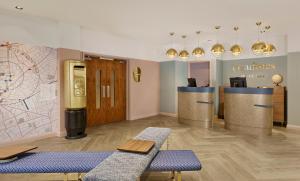 a waiting room with a check in counter and a map at Citadines Islington London in London