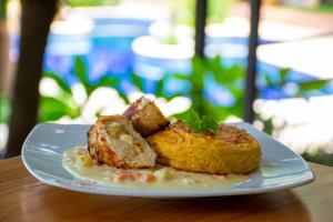 a white plate with food on a table at Los Lagos Resort Hotel in Capiatá