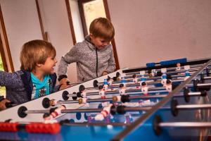 two young boys looking at a table with a chessboard at Jugendherberge Detmold in Detmold
