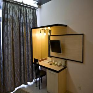 a room with a desk with a computer and a monitor at Staybridge Mini-Hotel in Most City PANORAMIC RIVER VIEW in Dnipro