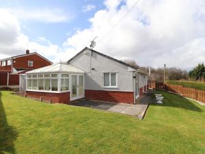 a house with a lawn in front of it at Enlli in Holywell