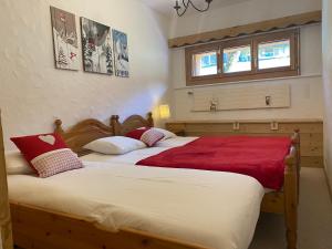two beds sitting next to each other in a bedroom at Apartment La Berciére 6 in Villars-sur-Ollon