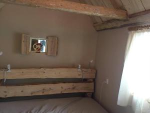 Schlafzimmer mit einem Bett mit einem Kopfteil aus Holz und einem Fenster in der Unterkunft Sivagerhuset Holiday-Home in Bogense
