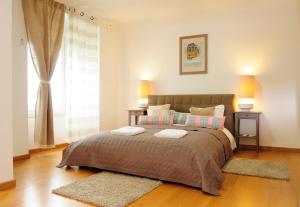 a bedroom with a large bed with two pillows at Cruz Apartments in Lisbon