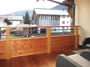 a deck with a fence and a view of a barn at Apartment Nina - UDS300 by Interhome in Uderns