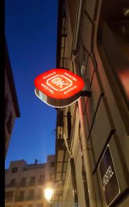 a red and white street sign hanging from the side of a building at Ok Hostel Madrid in Madrid
