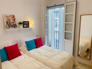 salon z białą kanapą i lustrem w obiekcie Bonito apartamento junto al Gran Teatro Falla w Kadyksie