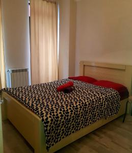 a bed with a black and white cheetah print blanket at tamunas apartment in Tbilisi City