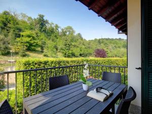 a wooden table with a book on a balcony at Apartment Fon 105 by Interhome in Fondotoce