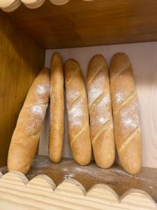 four rolls of bread sitting on a shelf at ALBERGUE de PEREGRINOS SEÑOR OSO in Molinaseca
