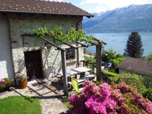 a cottage with a view of a lake and mountains at Rustico Storelli in Brissago