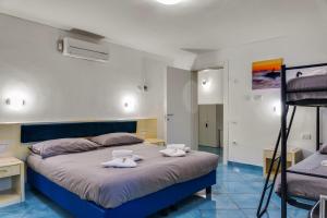 a bedroom with a large bed with towels on it at InVilla Seristori, a 50 m dal mare in San Vincenzo