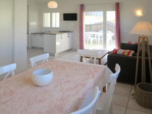 a kitchen and living room with a table and chairs at Holiday Home Résidence Plage Océane - BPL341 by Interhome in Biscarrosse-Plage