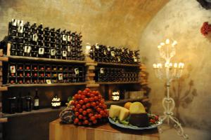 a table with a plate of cheese and wine bottles at Hotel Villa Fraulo in Ravello