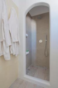 a bathroom with a shower with a mirror at Agnadi studios in Maltezana