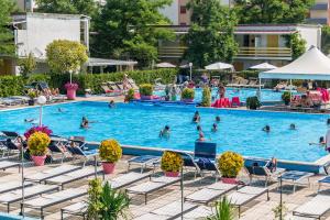 a pool at a hotel with people swimming in it at Blu Marlin Residence con piscina in Lido Adriano