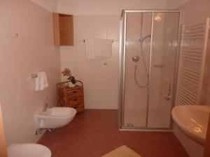 a bathroom with a shower and a toilet and a sink at Kerschbaumhof in San Candido