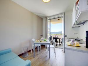 a kitchen and living room with a table and chairs at Apartment Isolino - FON106 by Interhome in Fondotoce +14 photos