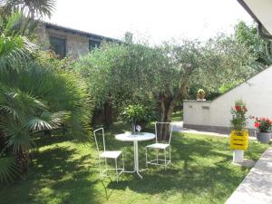 a garden with a table and chairs in the grass at Apartment Mia by Interhome in Montignoso