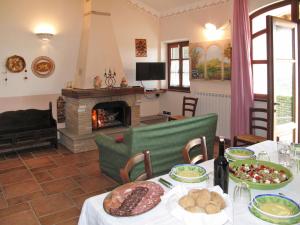 a living room with a table and a fireplace at Holiday Home Villetta degli Orti by Interhome in Montemagno