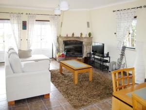 a living room with a white couch and a fireplace at Holiday Home All Welcome - TOV120 by Interhome in Sobreiro Curvo