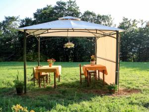 a gazebo with two tables and chairs under it at Apartment Sambucco - SBO102 by Interhome in Savona