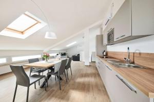 a kitchen and dining room with a table and chairs at Ribarska Koliba Resort in Pula