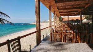 a restaurant on the beach with a view of the ocean at H&ograve;n Cau Resort & Restaurant in Tuy Phong