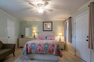een slaapkamer met een bed en een plafondventilator bij Blackbeard's Lodge in Ocracoke
