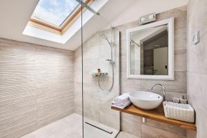 a bathroom with a sink and a glass shower at Ribarska Koliba Resort in Pula