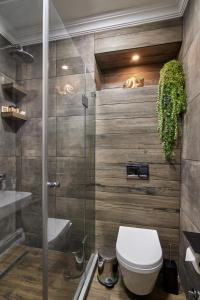 a bathroom with a toilet and a shower stall at Hotel City in Tbilisi City