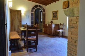 a dining room with a table and chairs in a room at Podere Scaluccia in Impruneta