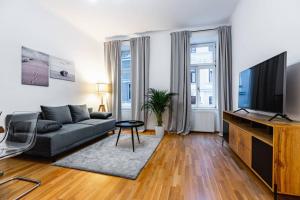 a living room with a couch and a flat screen tv at Spacious 3-room apt. 15 min to the city center in Vienna