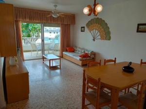 a living room with a table and a couch at Parque IV Solo Familias Serviplaya in Gandía