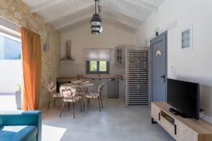 a kitchen and living room with a table and chairs at Amoroza Villa in Nydri