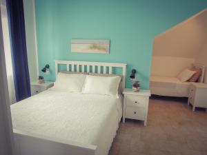 En eller flere senge i et værelse på B&B La Rosa dei Venti