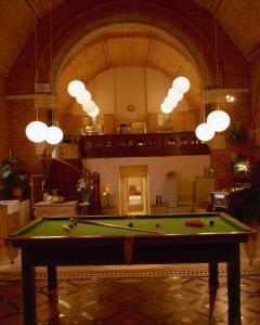 a pool table in the middle of a room at Mountain Church in Capel Curig
